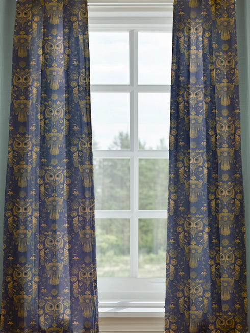 A sheer curtain panel featuring a repeating pattern of ornate golden owls surrounded by delicate floral designs and botanical elements on a deep navy background. The fabric has a fine linen-like texture with translucent qualities.